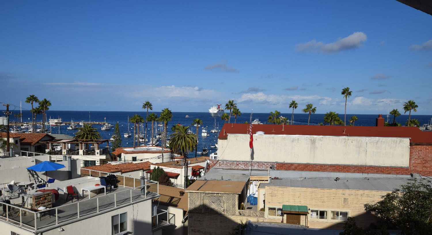 A view of the ocean over rooftops from the balcony of the Hotel Catalina